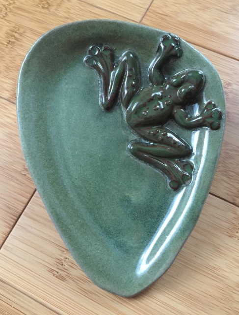 Frog spoon rest has a raised spotted green frog on aqua swirl glaze. It is  handmade ceramic in a round bowl shape with a notch to catch any gloop  keeping your stove